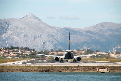 Scenic view of sea and mountains against sky