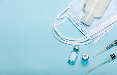 High angle view of objects on table against blue background