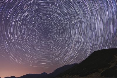 Scenic view of mountains against sky at night