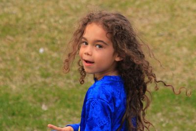 Portrait of child standing on grass