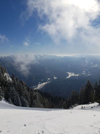 Scenic view of snow covered mountains against sky