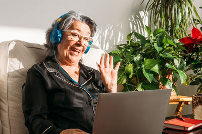 Young woman using laptop at home