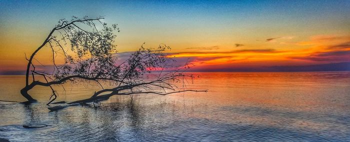 Scenic view of sea against sky at sunset