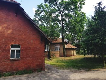 House by trees against sky