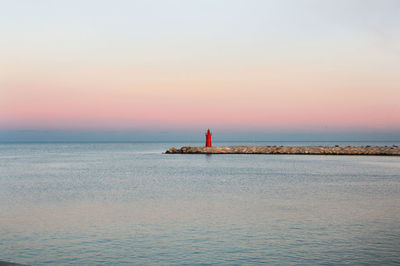 Scenic view of sea against clear sky at sunset