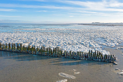 Scenic view of sea against sky during winter