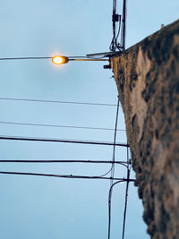 Low angle view of electricity pylon against sky