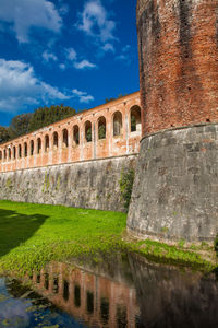 Arch bridge over canal against sky