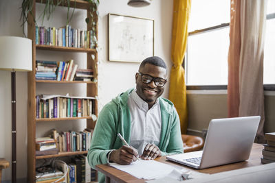 Portrait of happy man working at home