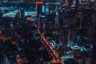 High angle view of illuminated buildings in city at night