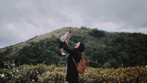 Mother playing with son against mountains