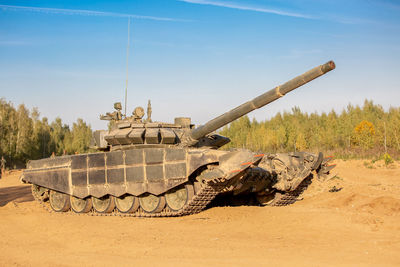 View of armored tank on land against sky