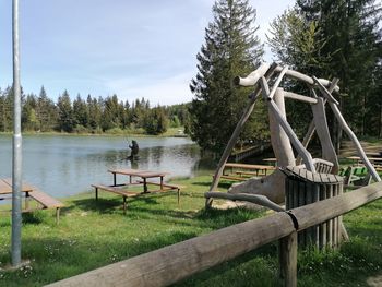 Gazebo by lake against sky