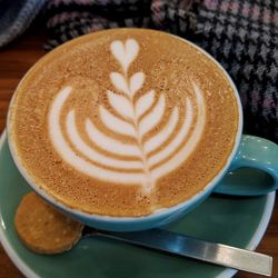 High angle view of cappuccino served on table