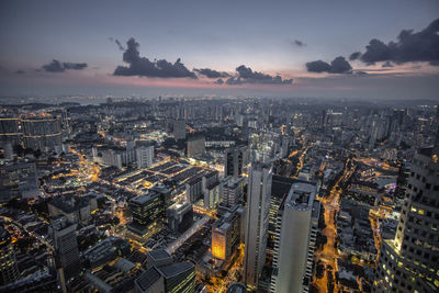 High angle view of illuminated city against sky during sunset