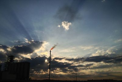 Low angle view of street light against cloudy sky