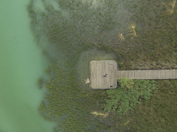 Aerial view of people on boardwalk against sea