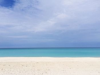 Scenic view of sea against cloudy sky