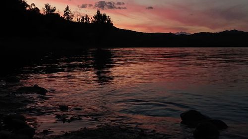 Scenic view of lake against sky during sunset