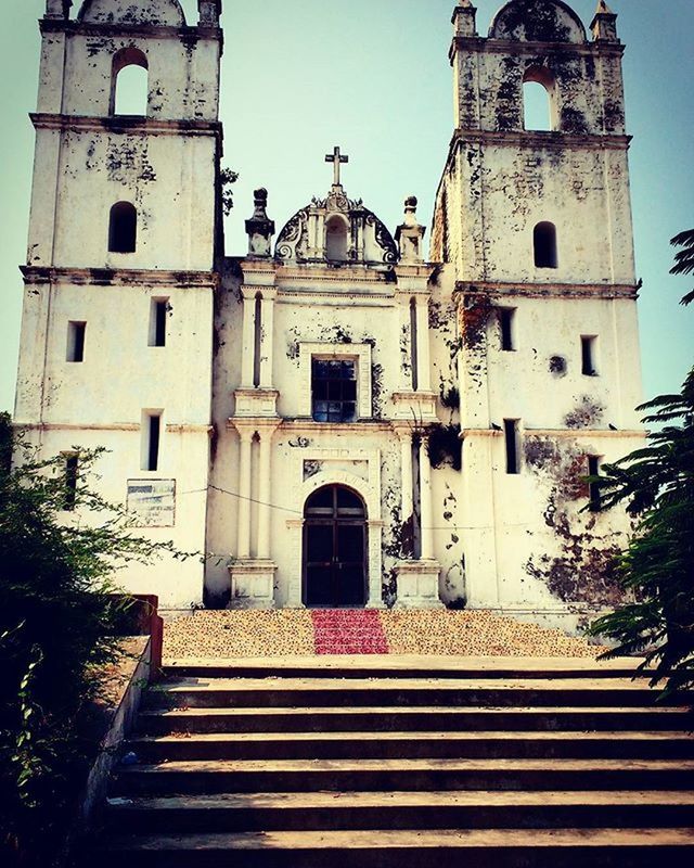 architecture, built structure, building exterior, place of worship, religion, church, steps, low angle view, spirituality, steps and staircases, history, sky, staircase, cathedral, travel destinations, clear sky, day, facade