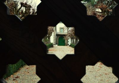 Close-up of built structure with trees in foreground