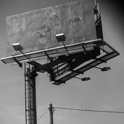 Low angle view of crane against sky