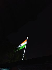 Low angle view of flag against sky at night