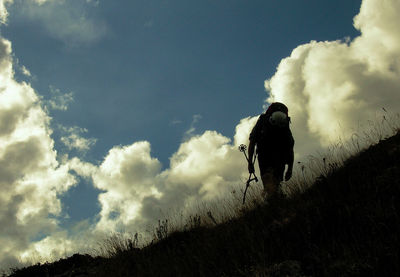 Low angle view of silhouette man standing against sky