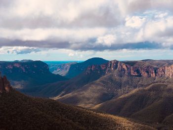 Scenic view of mountains against cloudy sky