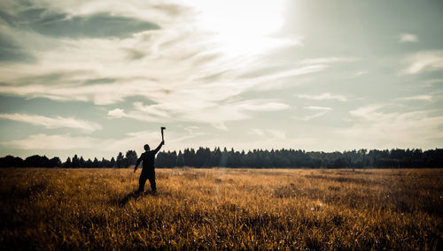 People standing on field against sky