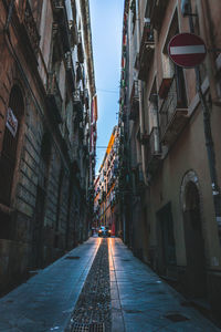 Narrow alley amidst buildings in city