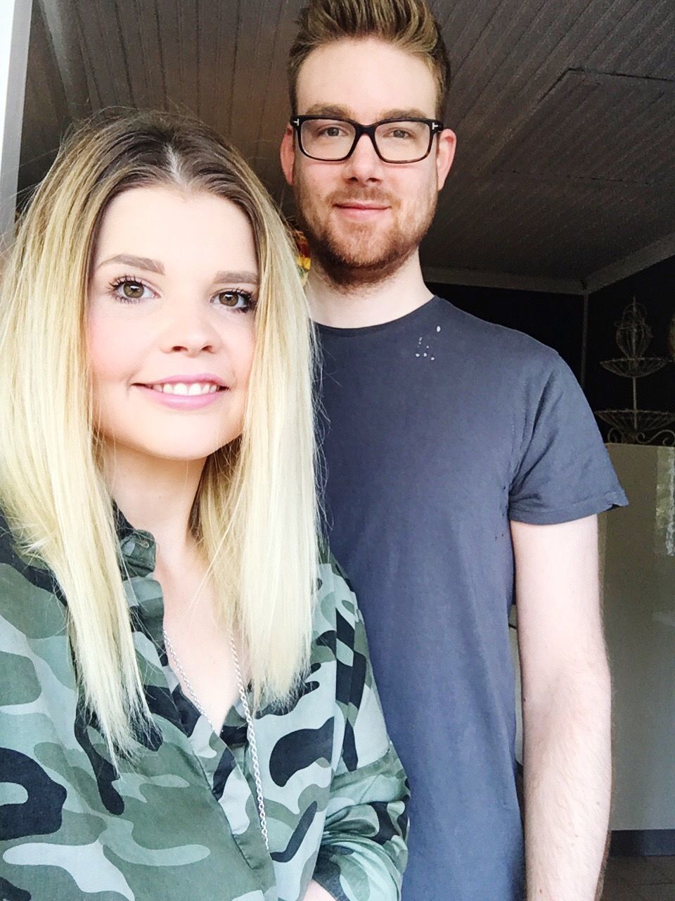 looking at camera, portrait, smiling, two people, eyeglasses, young adult, happiness, real people, young men, young women, blond hair, togetherness, beard, front view, casual clothing, love, standing, day, indoors, friendship, cheerful, beautiful woman, people