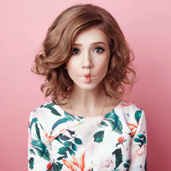 Portrait of a beautiful young woman against gray background