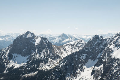 Scenic view of snow covered mountains against sky