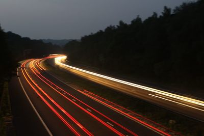 High angle view of light trails on highway at night