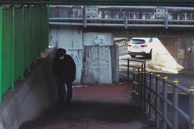 Rear view of people walking on footpath