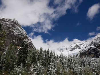 Low angle view of snowcapped mountain against sky