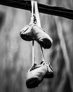 Low angle view of shoes hanging on rope