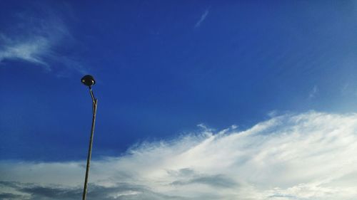 Low angle view of street light against blue sky