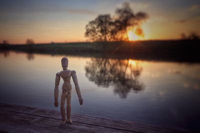 Full length of lake against sky during sunset