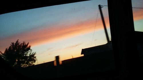 Low angle view of silhouette building against sky during sunset