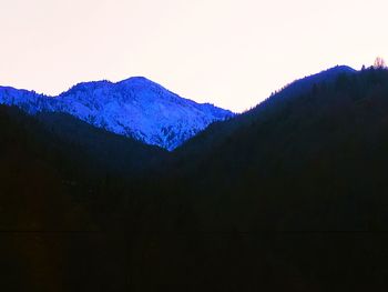 Scenic view of snowcapped mountains against clear sky