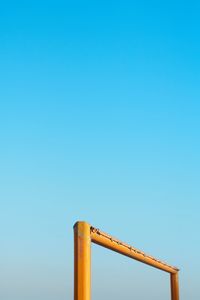 Low angle view of metallic structure against blue sky