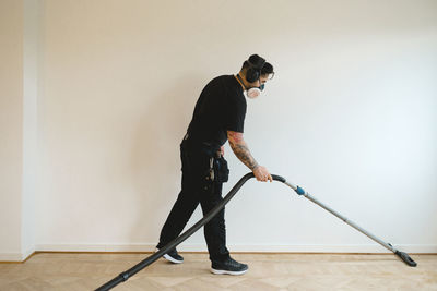 Man hoovering parquet floor