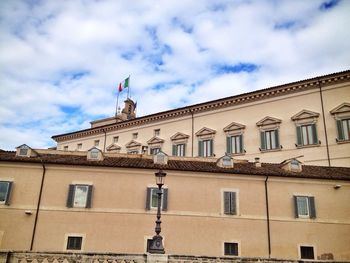 Low angle view of building against cloudy sky