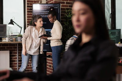 Portrait of smiling friends standing in cafe