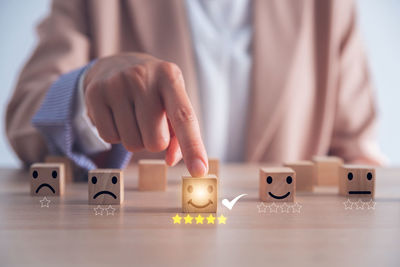 Midsection of businessman with toy blocks