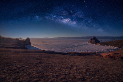 Scenic view of desert against sky at night