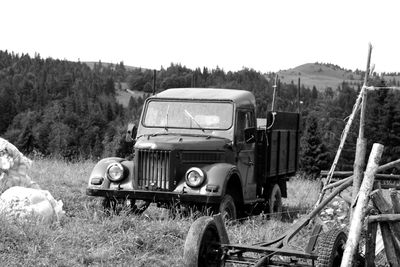 Abandoned truck on field against sky