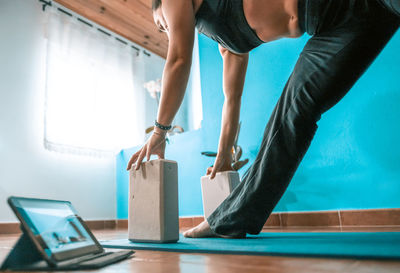 Low section of woman standing on table